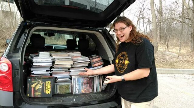 Me, looking excited, standing in front an of SUV with the entire trunk full of RPGs books.