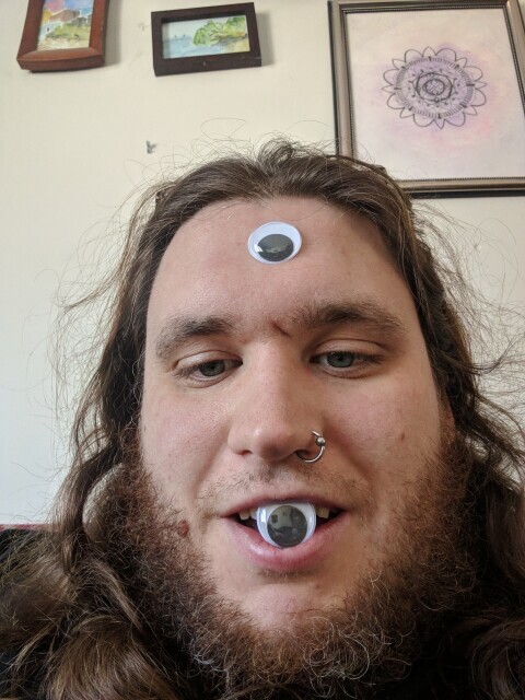 Me with a googly  eye on my forehead and in my mouth
