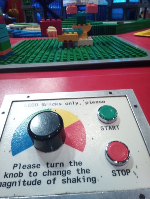A lego structure on a baseboard with controls showing how intensely it will be shaken