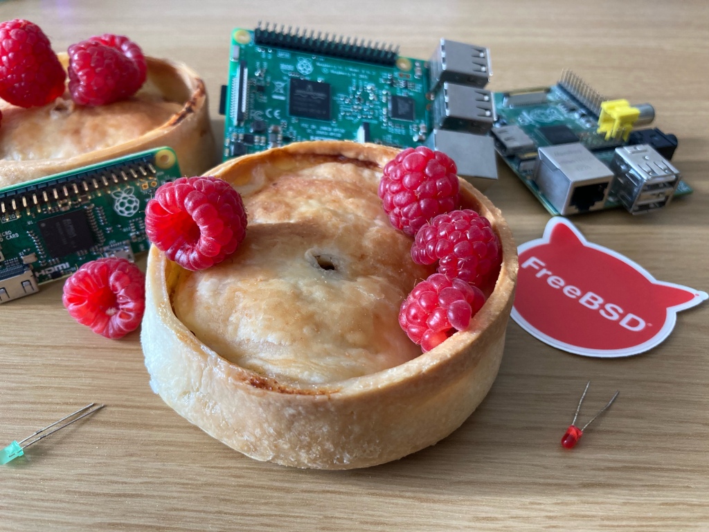 A scotch pie with some raspberries on top with some arduinos in the background. 

For accessibility’s sake they are actually raspberry pis