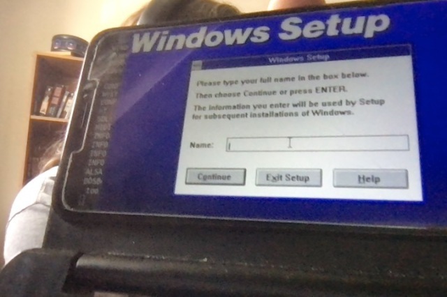 A pinephone with keyboard case installing Windows 3.1 in dosbox
